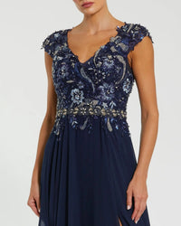 Navy blue dress with intricate beadwork on a white background