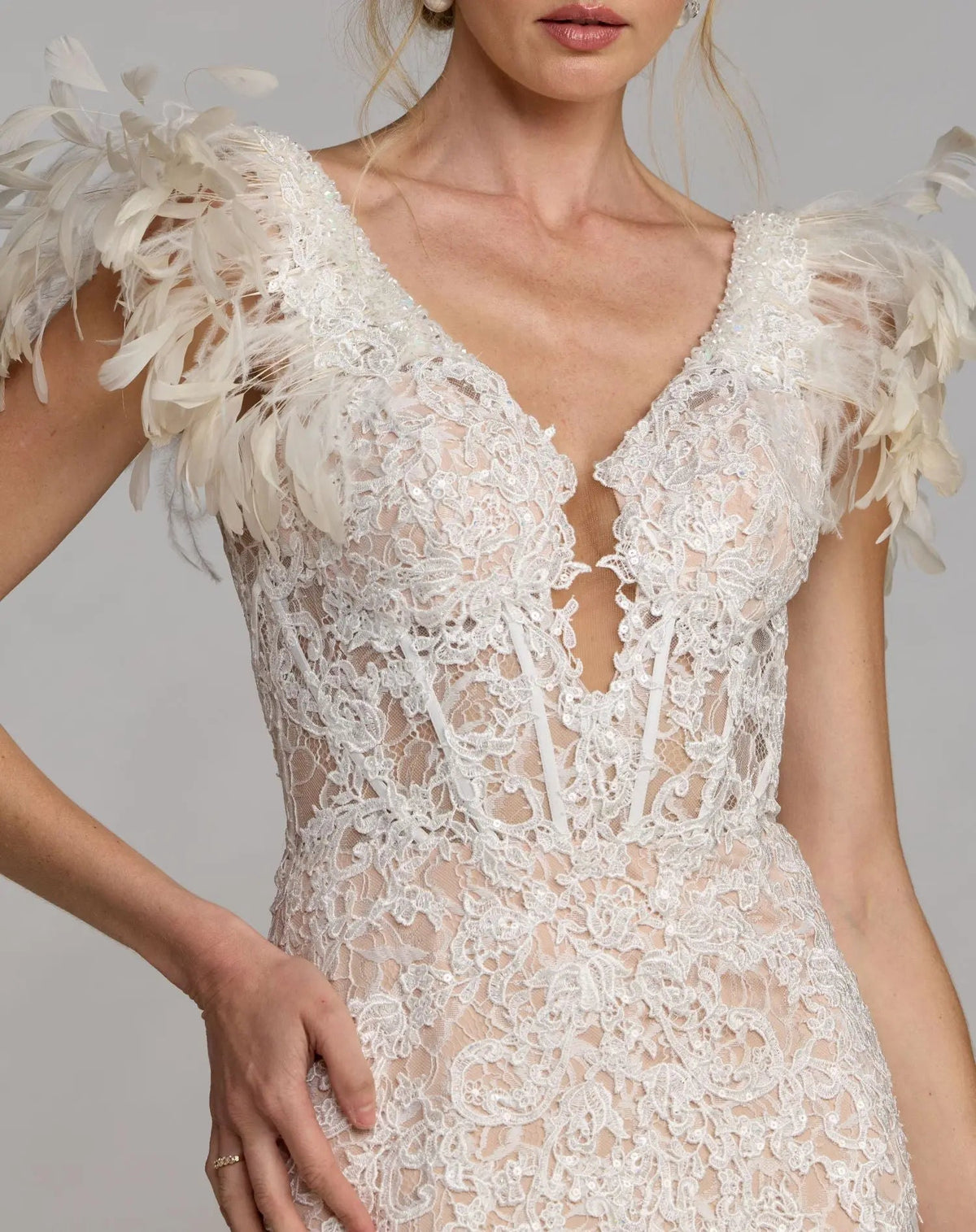 Close-up detail of cap sleeve feather accents on Mac Duggal 79453 ivory lace gown