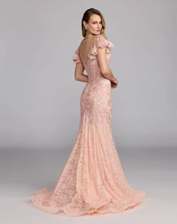 Back view of the blush mermaid gown, showcasing the sheer illusion back and flared silhouette.
