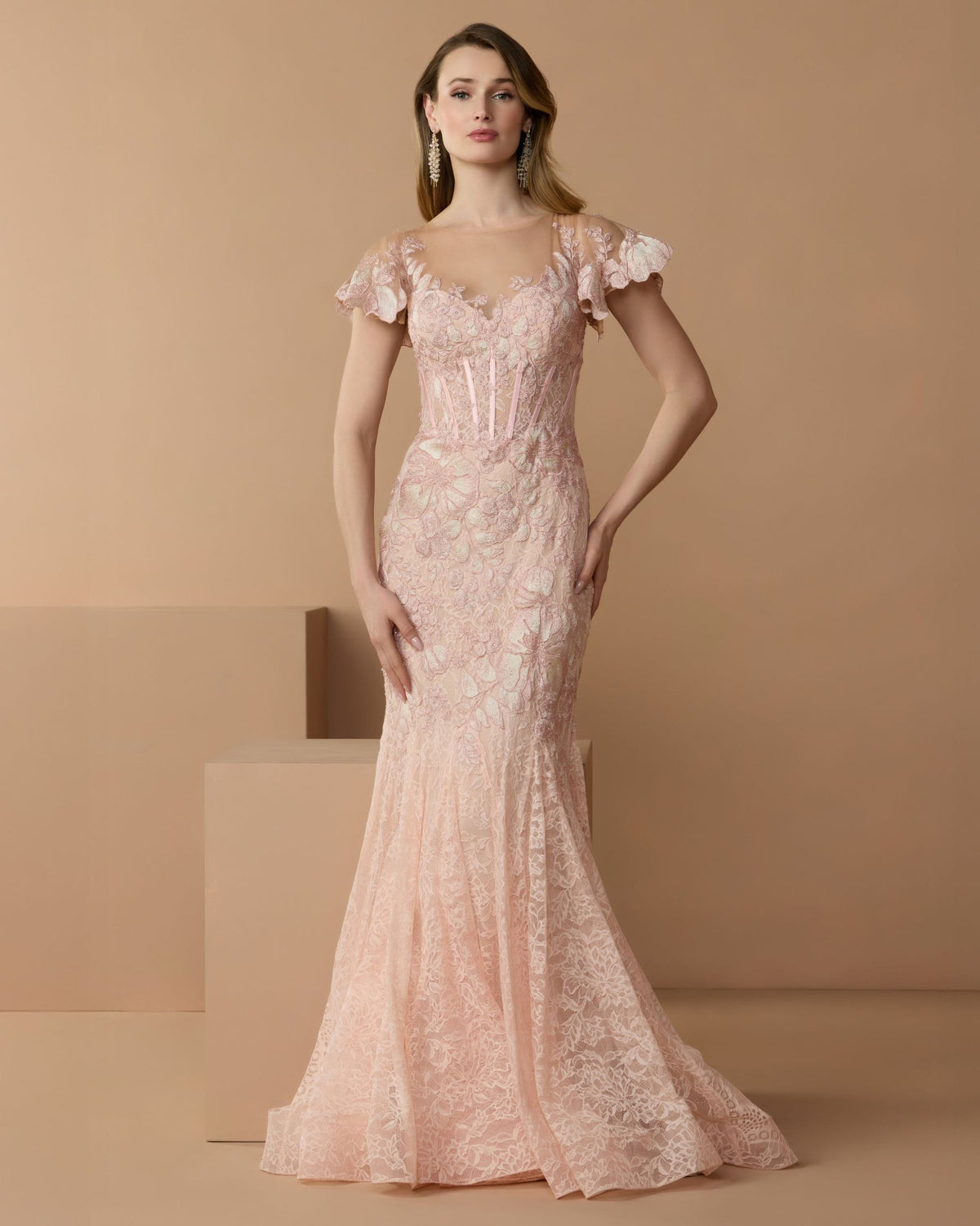Full-length front studio view of the blush mermaid gown with floral embroidery and flutter cap sleeves.
