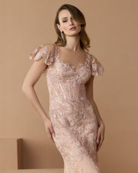 Lifestyle close-up shot of the embroidered bodice and flutter sleeves.