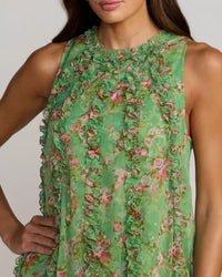 Green floral dress worn by a model on a plain background