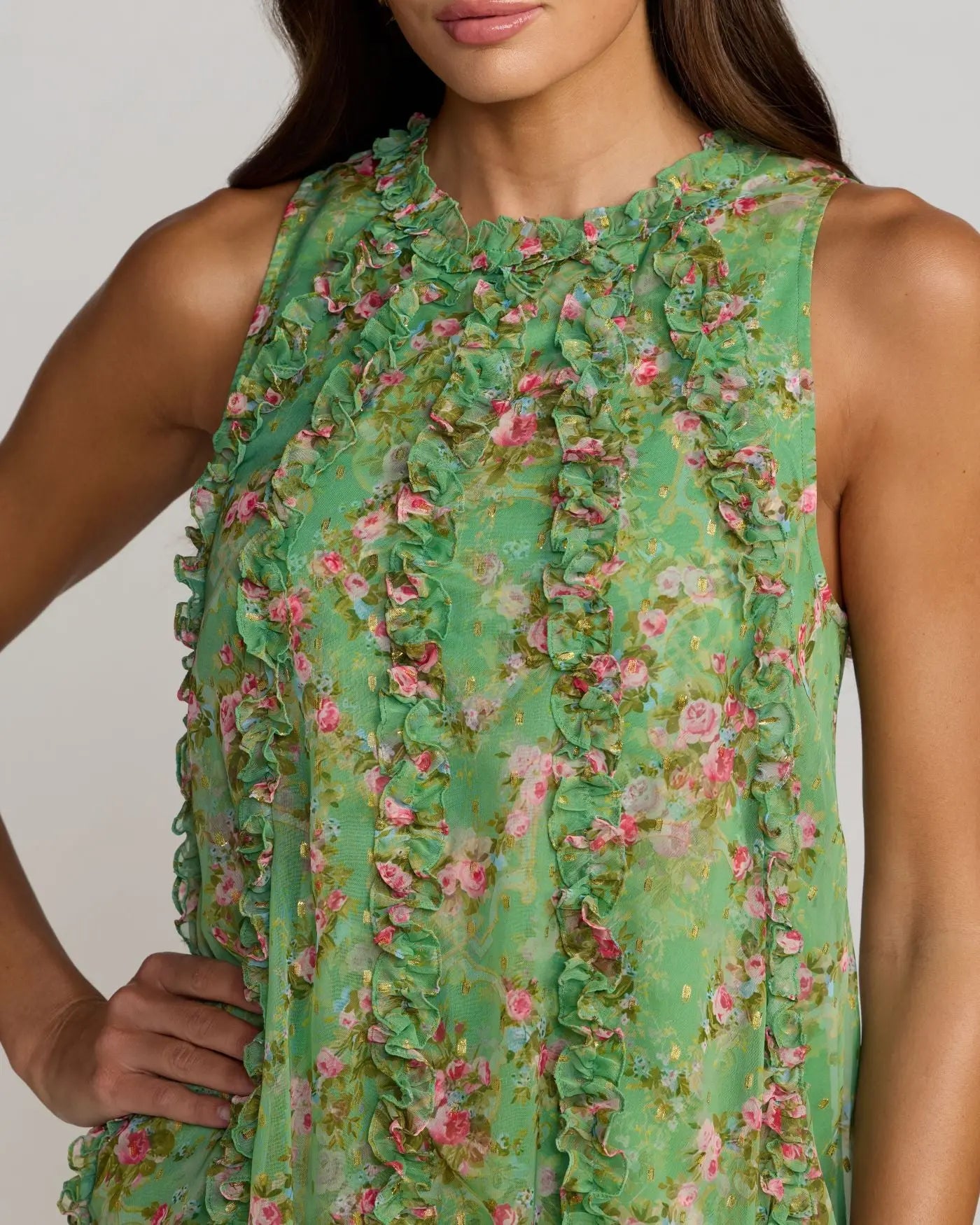 Green floral dress worn by a model on a plain background