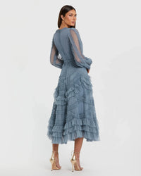 Woman wearing a blue ruffled dress on a white background