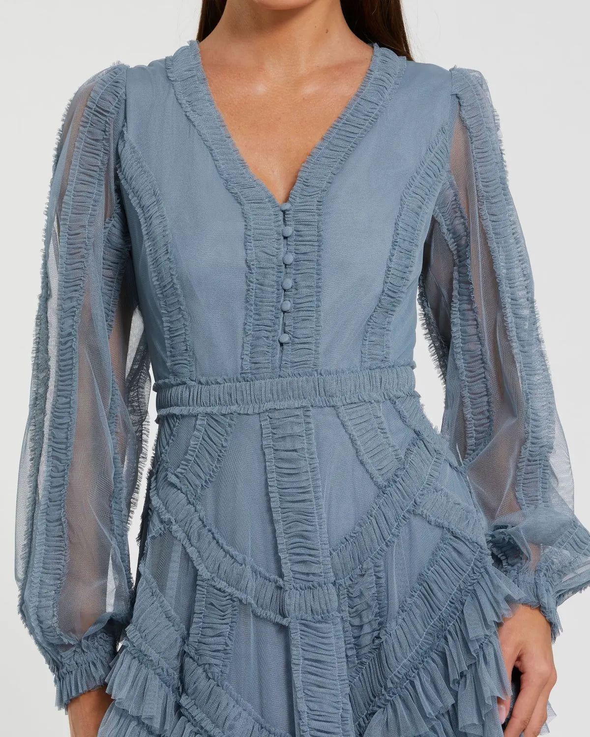 Blue dress with ruffled details on a plain background