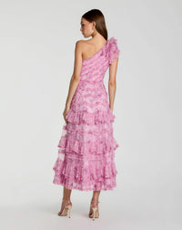 Woman wearing a pink one-shoulder dress with ruffled layers on a white background