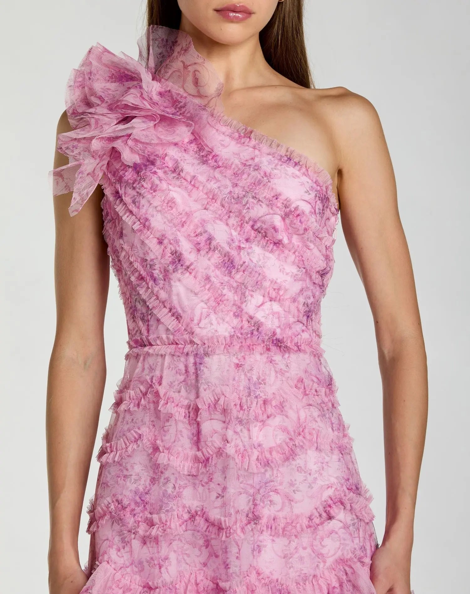 Pink one-shoulder dress with floral pattern on a white background