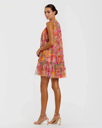 Woman wearing a colorful floral dress on a white background