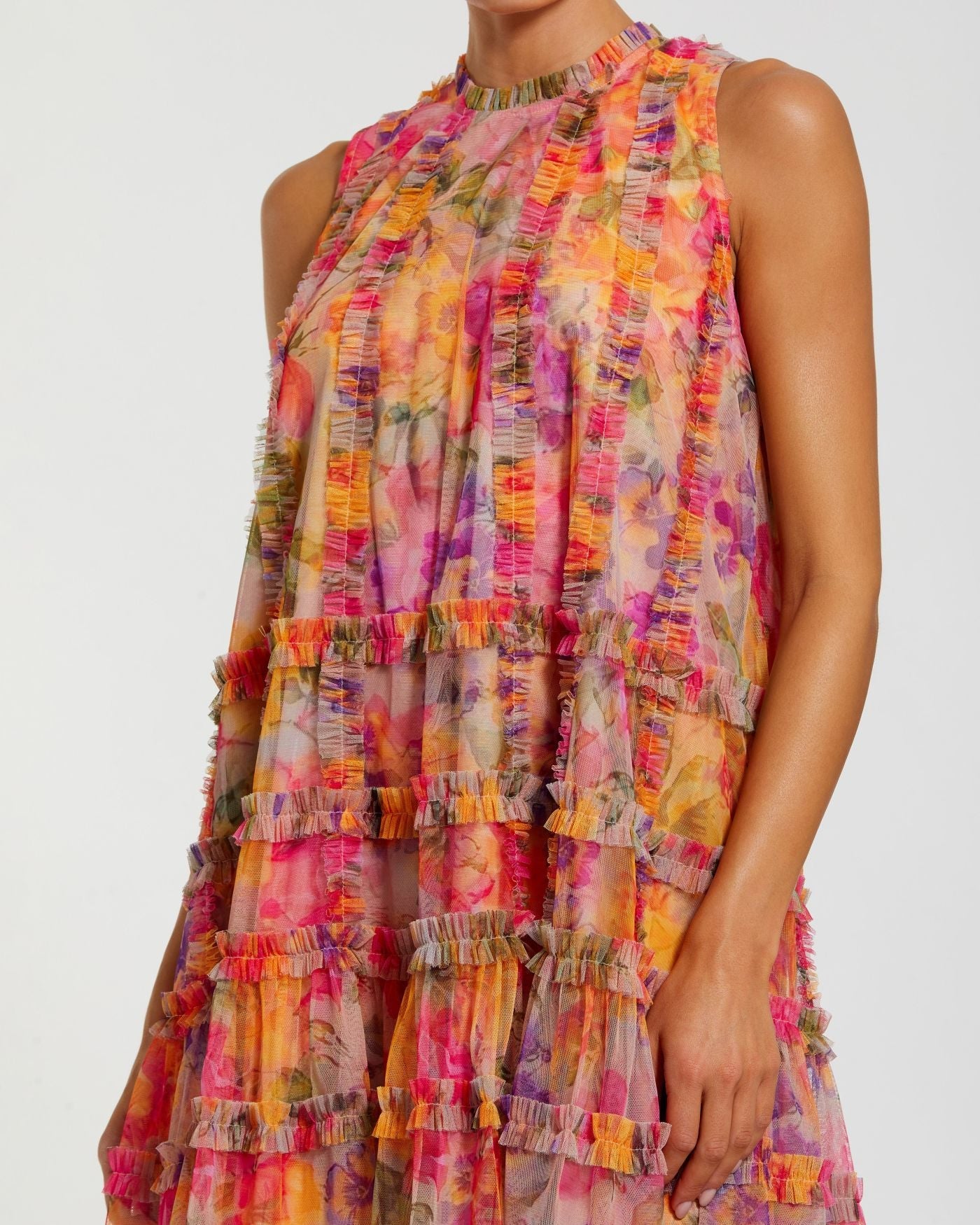 Multicolored tiered dress on a plain background