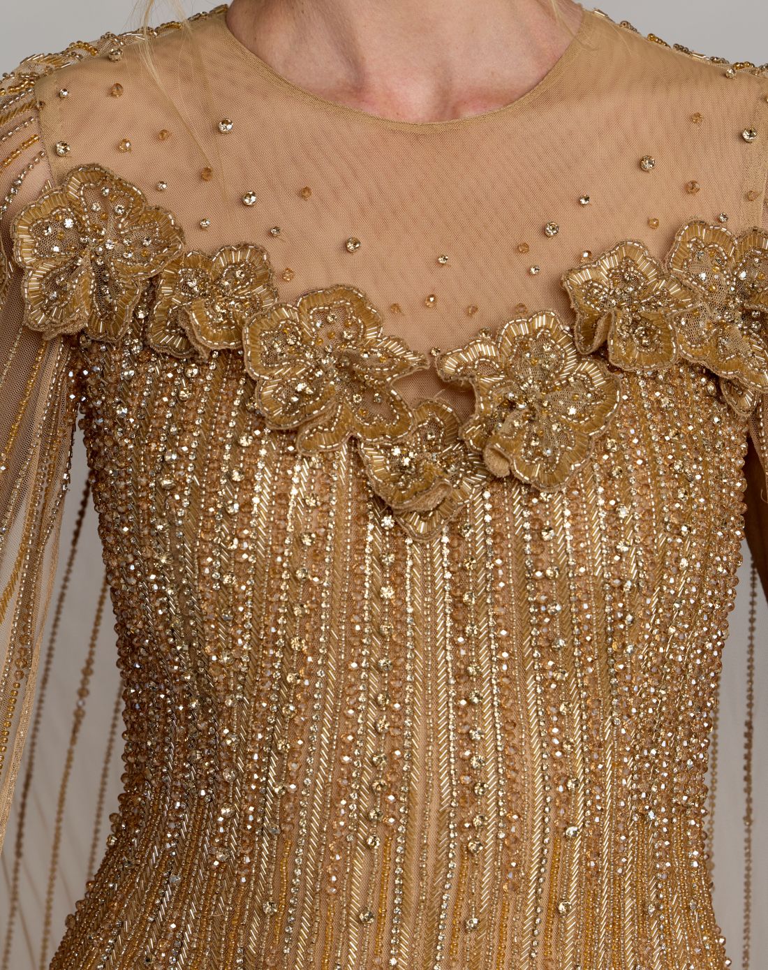 Detailed view of the densely concentrated beadwork and floral appliqués on the bodice of Mac Duggal 86012 Nude Gold gown