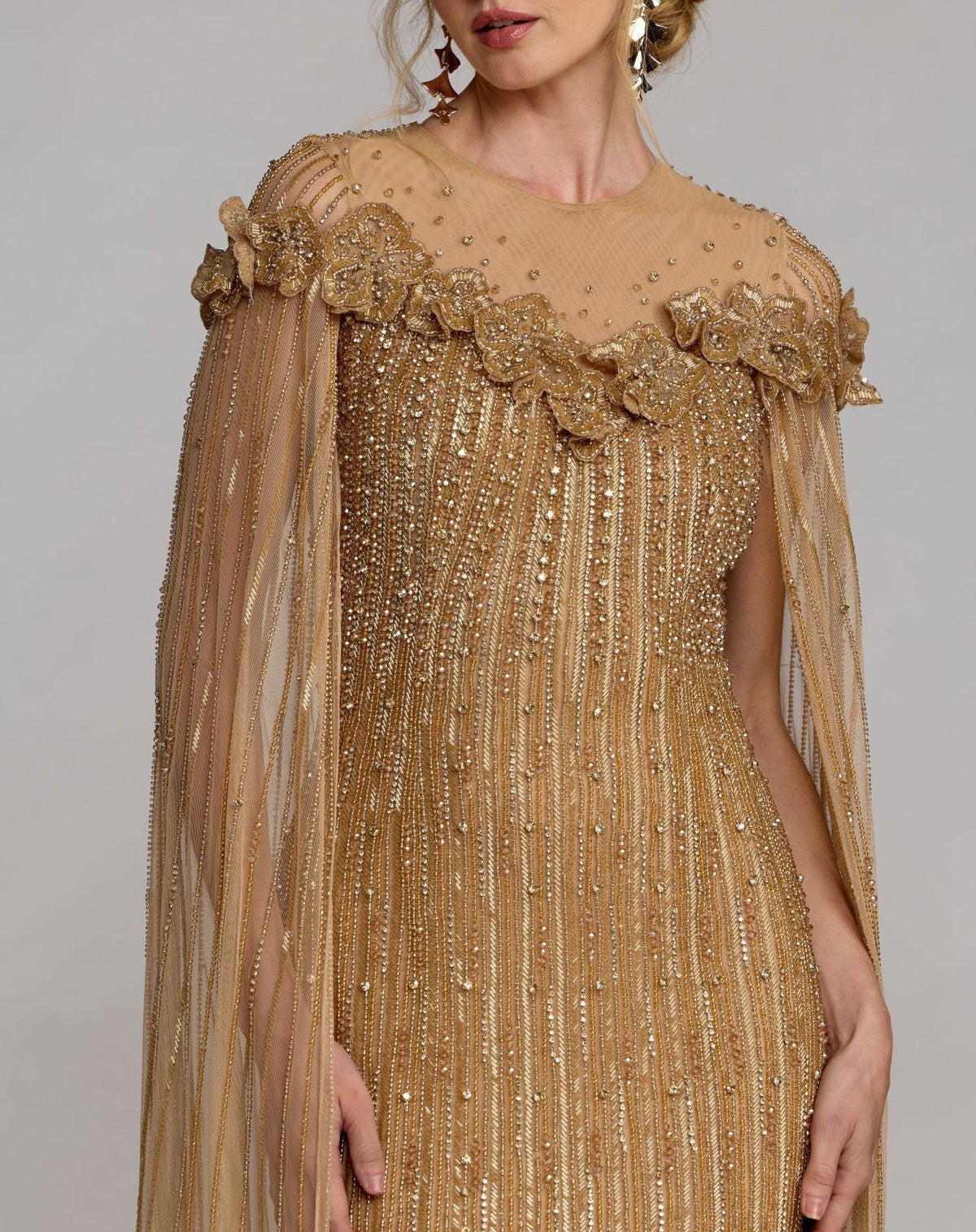 Close-up of 3D floral appliqués and beaded detailing on the neckline of Mac Duggal 86012 Nude Gold gown