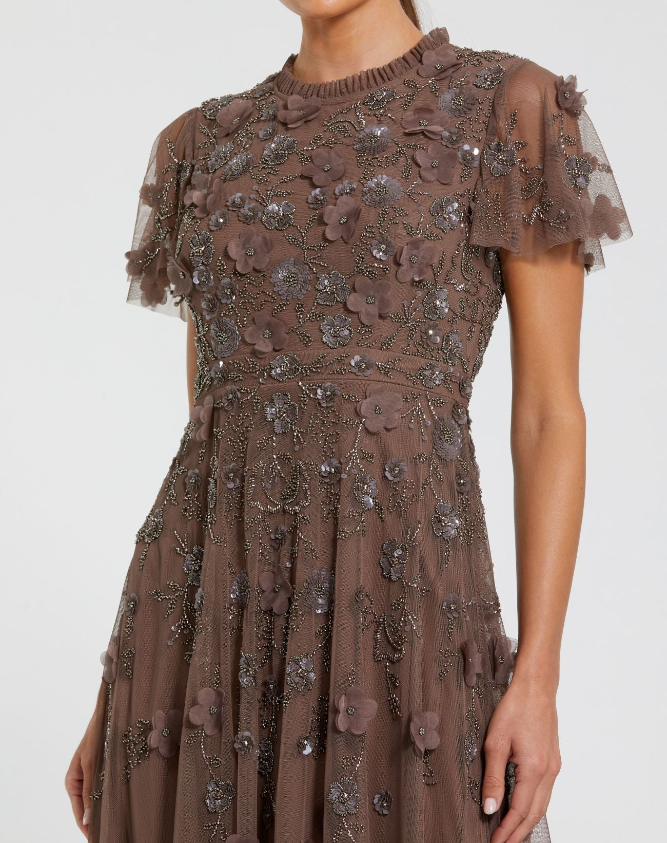 Brown dress with floral embroidery on a white background