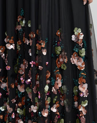 Close up of delicate floral beadwork and embroidery on black dress