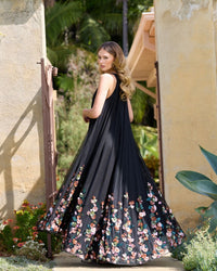 Back view of model in sleeveless black gown with floral details