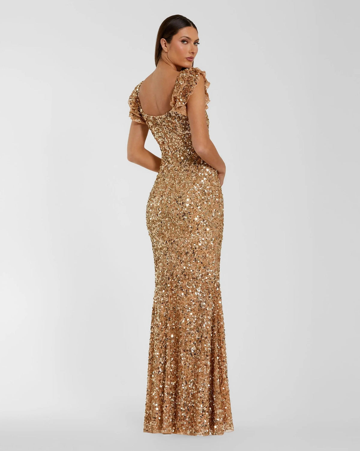 Back view of a gold sequin floor-length trumpet gown with a concealed back zipper.