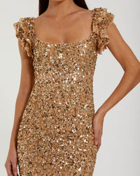 Close-up view of the bodice and flutter cap sleeves on a gold sequin gown.
