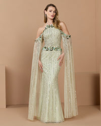 Full-length front studio view of the seafoam embellished mesh column gown with draped cape sleeves.