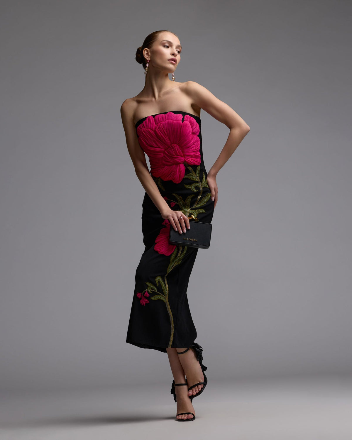 Detailed-embroidery-and-sculptural-botanical-accents-on-black-gown