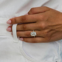 Hand model lifestyle shot wearing the 5 carat emerald cut celebrity style engagement ring inspired by Nicola Peltz Beckham on a delicate diamond pavé band.