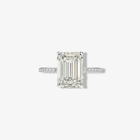 Front studio macro view of a Margalit Rings 5 carat emerald cut diamond simulant engagement ring with classic prongs and a brilliant micro pavé sterling silver band.