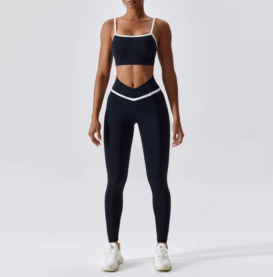 Give your off-duty wardrobe a new lease of life with this monochrome gym crop top and full length leggings set. This cropped cami top with hidden padding is brought to you in a monochrome black and white style with white piping straps and a seamless design. This gym fit set is everything you need for your everyday errands, pilates or for your gym session. 