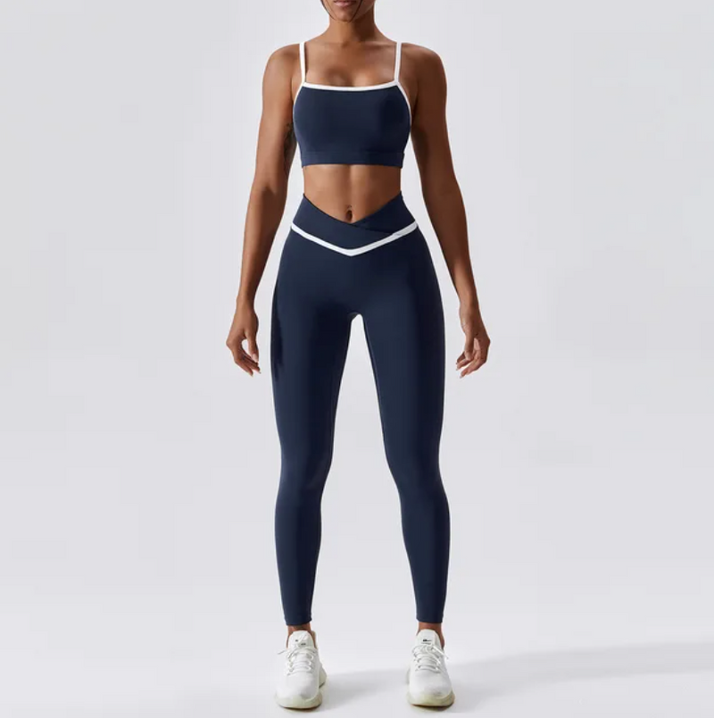 Give your off-duty wardrobe a new lease of life with this monochrome gym crop top and full length leggings set. This cropped cami top with hidden padding is brought to you in a monochrome navy and white style with white piping straps and a seamless design. This gym fit set is everything you need for your everyday errands, pilates or for your gym session. 