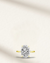 hailey bieber engagement ring dupe, oval diamond on yellow band