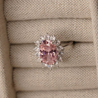 Pink oval sapphire halo cocktail ring worn