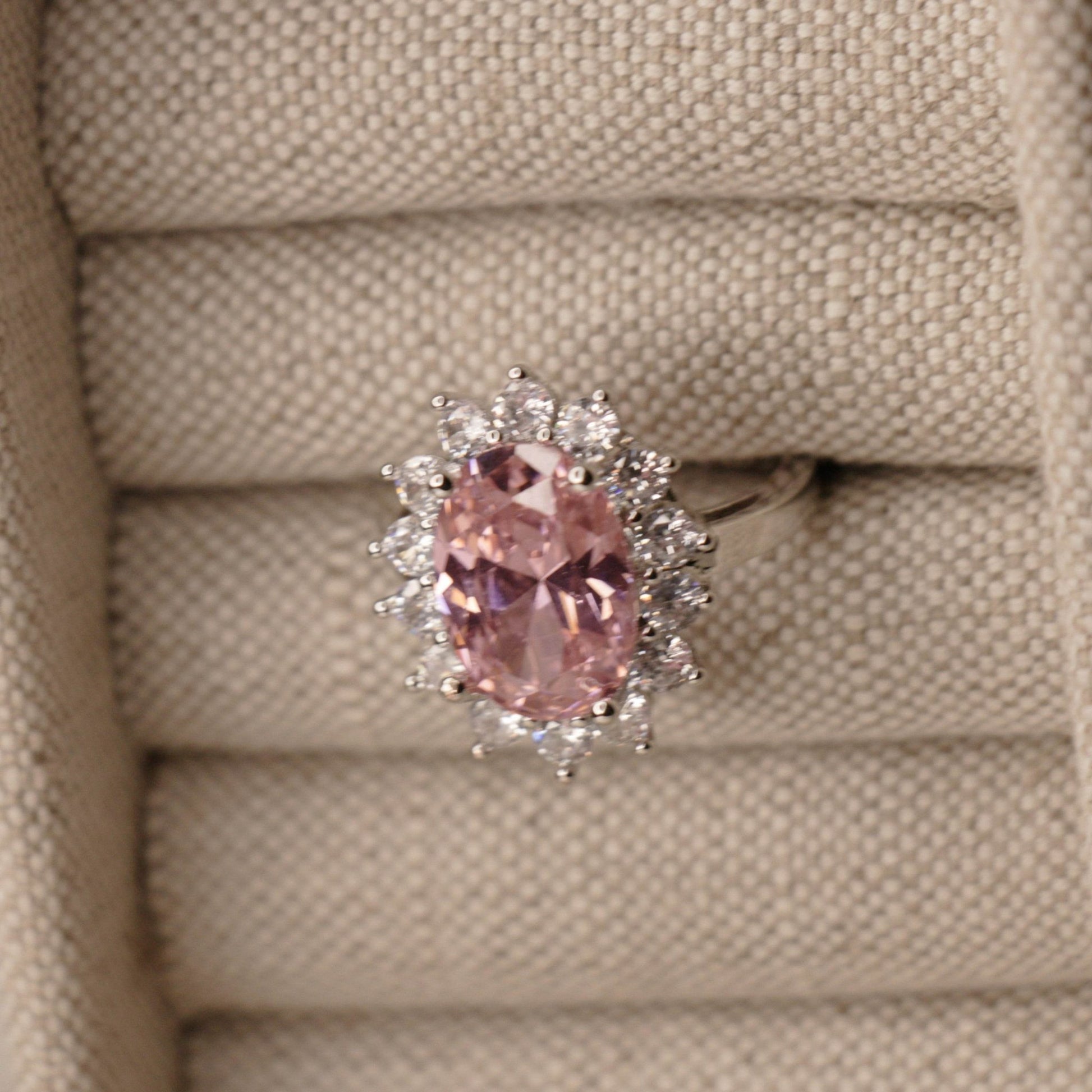 Pink oval sapphire halo cocktail ring worn