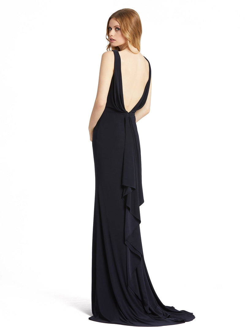This stunning, midnight, sleeveless faux-wrap v-neck jersey gown featuring a plunging-v back, gathered sweeping train, and high front slit is a beautiful, full-length evening dress perfect for proms, black-tie affairs, weddings and special events back