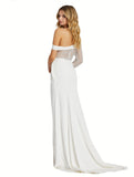 This elegant Mac Duggal ivory, bridal perfect, floor-length, asymmetric one sleeved illusion gown features punch pearls and rhinestones throughout the bodice and sleeve to create beautiful bridal detail. Finished with a crepe jersey skirt to hug your every curve and accented by a modern pin-tucked side peplum and thigh-high slit.This gown is perfect for proms, black-tie affairs, weddings, brides and special events back view