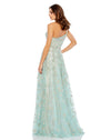 This incredible sage green gown is made from shimmery, botanical-embroidered tulle with with a rhinestone trim at the waist and topped with a feminine full bow at the single shoulder. It’s glamorous, romantic—and with a high leg slit—flirty, too. This gown is perfect for wedding guests and Summer parties back view