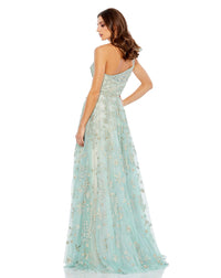 This incredible sage green gown is made from shimmery, botanical-embroidered tulle with with a rhinestone trim at the waist and topped with a feminine full bow at the single shoulder. It’s glamorous, romantic—and with a high leg slit—flirty, too. This gown is perfect for wedding guests and Summer parties back view