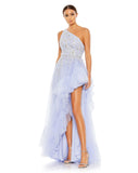 Made in a pretty shade of periwinkle blue in tulle with a lining to match, the unique gown is styled with a one-shoulder topline, botanical embroidery, glittering rhinestone accents, and ruffle trim. The dress trades a more traditional slit for a dramatic asymmetrical cut that highlights lots of leg.