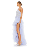 Made in a pretty shade of periwinkle blue in tulle with a lining to match, the unique gown is styled with a one-shoulder topline, botanical embroidery, glittering rhinestone accents, and ruffle trim. The dress trades a more traditional slit for a dramatic asymmetrical cut that highlights lots of leg side view