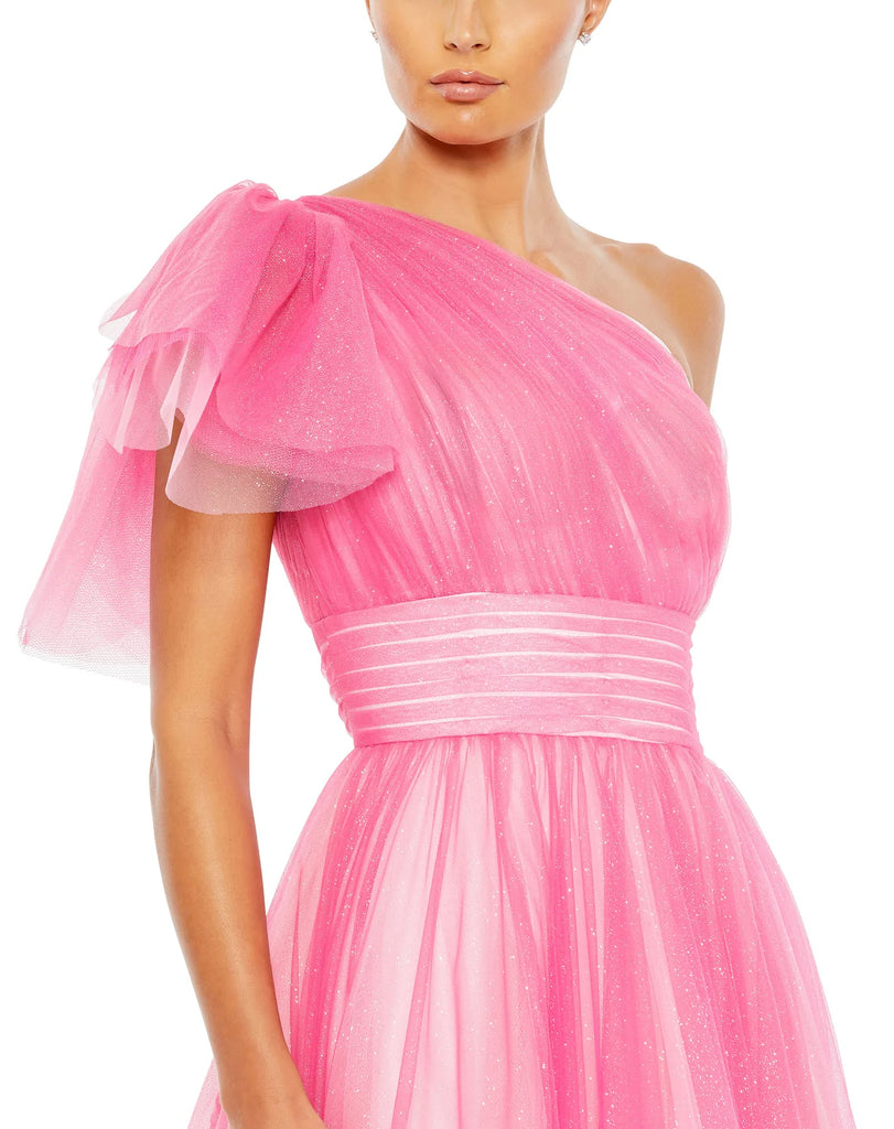 This very special, hot pink, floor length, princess A line ball gown will make you feel like. true Hollywood movie-star. Made with light-catching glitter-flecked tulle, this effervescent ball gown is styled with a one-shoulder top with a fluttery statement sleeve, a pleated waistband, and full, feminine skirt. This elegant formal dress is picture for balls, weddings and special occasions close up