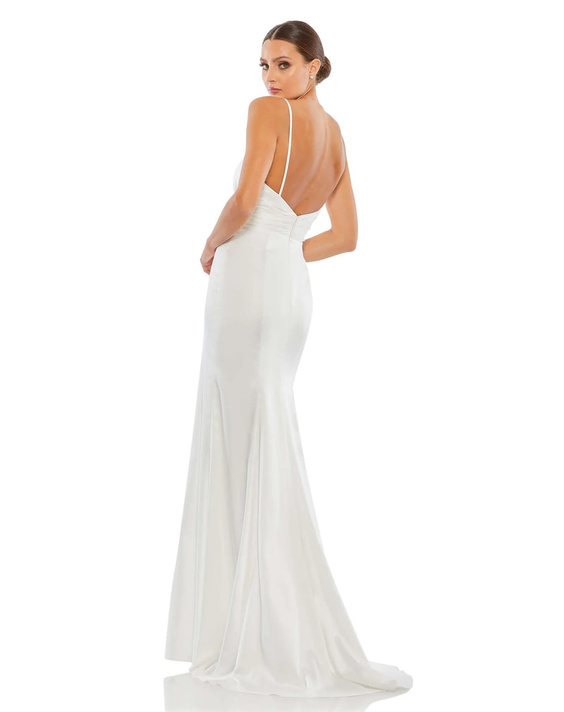 This elegant Grecian inspired, Mac Duggal white, bridal perfect, floor-length, faux-wrap evening gown features delicate spaghetti straps, a plunging chest, a fitted bodycon fit and a sweeping train. This charmeuse gown is perfect for proms, black-tie affairs, weddings, brides and special events back view