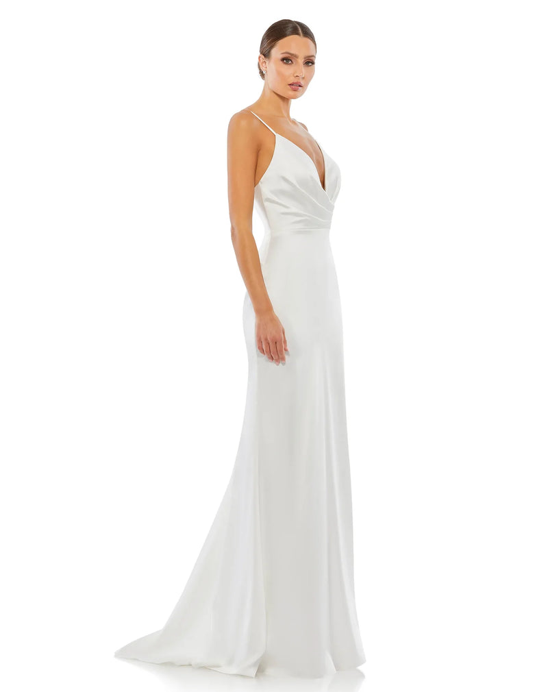 This elegant Grecian inspired, Mac Duggal white, bridal perfect, floor-length, faux-wrap evening gown features delicate spaghetti straps, a plunging chest, a fitted bodycon fit and a sweeping train. This charmeuse gown is perfect for proms, black-tie affairs, weddings, brides and special events side view