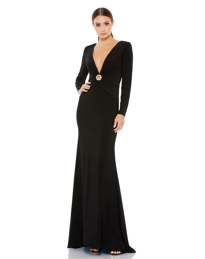 This elegant Mac Duggal long, black, long-sleeve jersey gown with a plunging v-neckline, gathered waist, and jewelled keyhole midriff is the perfect dress perfect for proms, black-tie affairs, weddings and special events!