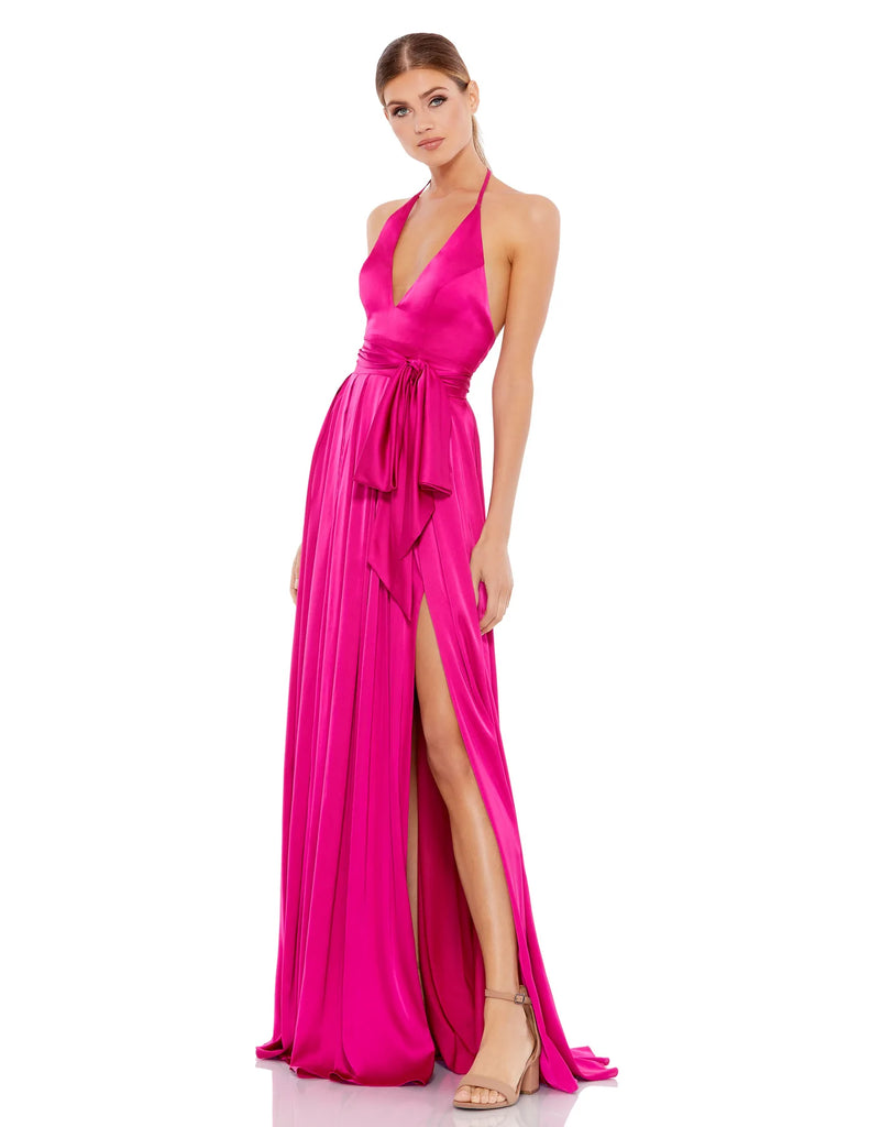 This elegant, floor-length, Mac Duggal, hot pink, magenta evening dress is a beautiful, Grecian inspired evening gown. Crafted with satin charmeuse, this halter gown features a plunging v-neckline, sexy open back, a self-tie belted waist, and a floor-length box pleated skirt with a thigh-high slit and sweeping train. This gown is perfect for proms, black-tie affairs, weddings and special events!