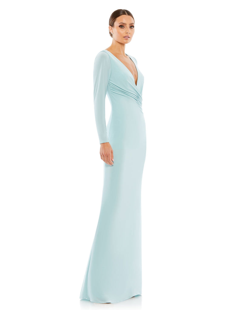 This elegant Mac Duggal powder-blue, evening dress is a beautiful, long, simple and sleek, chic jersey gown. Cut with a curve-hugging fit, the dress is fashioned with a deep surplice neckline, long sleeves and pleating at the waist. This gown is perfect for proms, black-tie affairs, weddings and special events! side