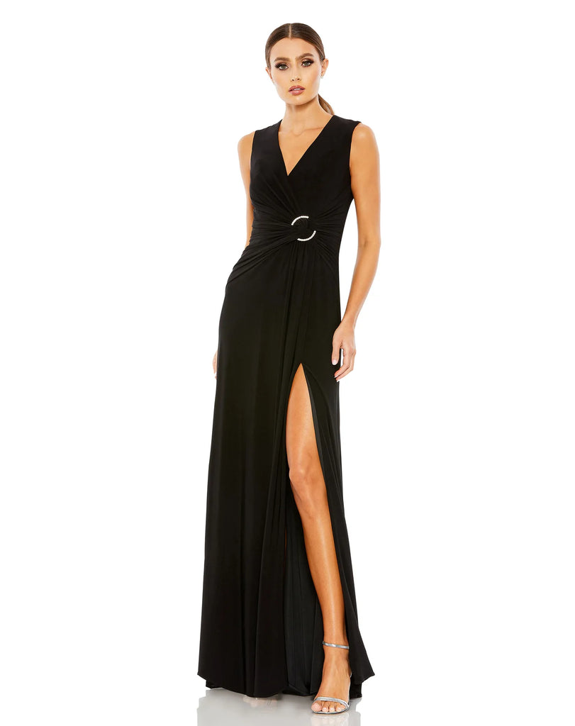 This elegant Mac Duggal floor-length, black short sleeve, evening dress is a beautiful, long, simple and sleek, jersey gown with gathering at the waist finished with a rhinestone buckle and a sexy leg slit to create easy and simple movement. This gown is perfect for proms, black-tie affairs, weddings, brides and special events!