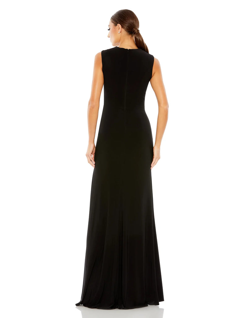 This elegant Mac Duggal floor-length, black short sleeve, evening dress is a beautiful, long, simple and sleek, jersey gown with gathering at the waist finished with a rhinestone buckle and a sexy leg slit to create easy and simple movement. This gown is perfect for proms, black-tie affairs, weddings, brides and special events back view