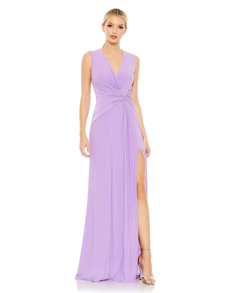 This elegant Mac Duggal floor-length, lilac, short sleeve, evening dress is a beautiful, long, simple and sleek, jersey gown with gathering at the waist finished with a rhinestone buckle and a sexy leg slit to create easy and simple movement. This gown is perfect for proms, black-tie affairs, weddings, brides and special events!