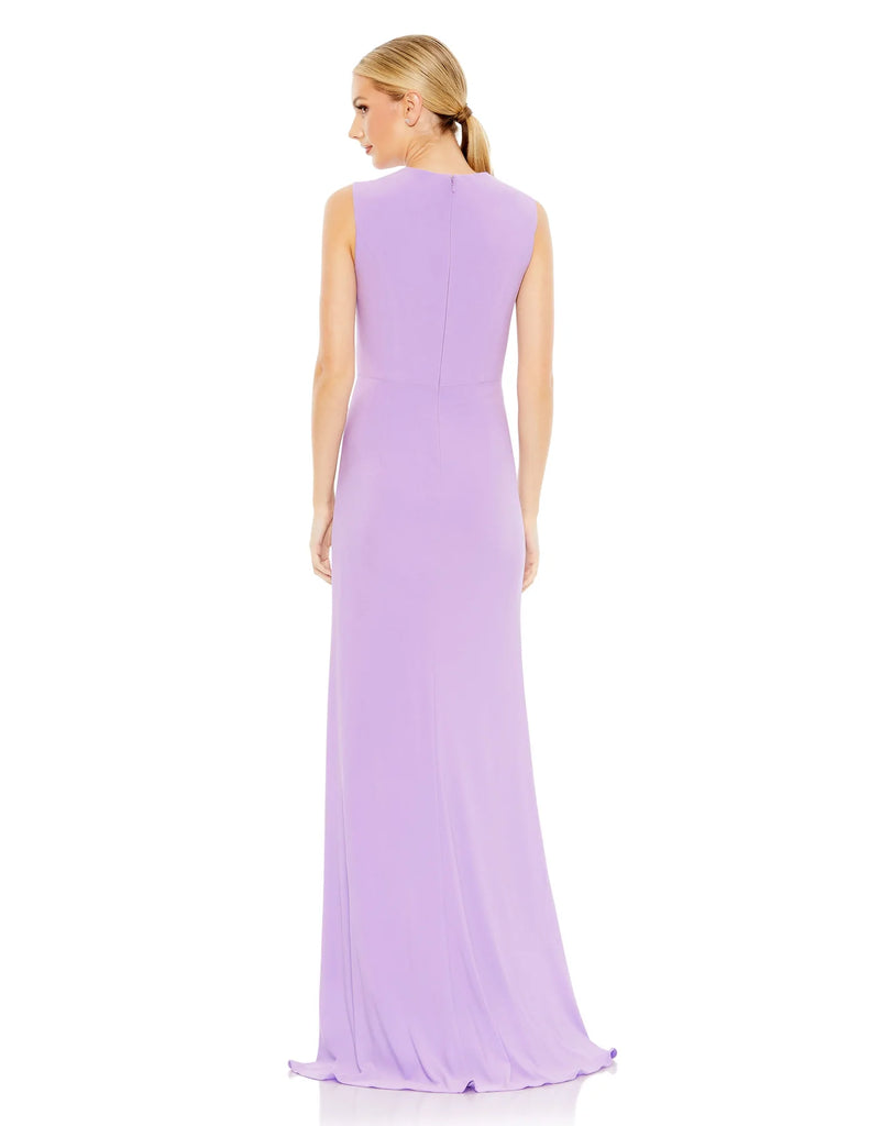 This elegant Mac Duggal floor-length, lilac, short sleeve, evening dress is a beautiful, long, simple and sleek, jersey gown with gathering at the waist finished with a rhinestone buckle and a sexy leg slit to create easy and simple movement. This gown is perfect for proms, black-tie affairs, weddings, brides and special events back view