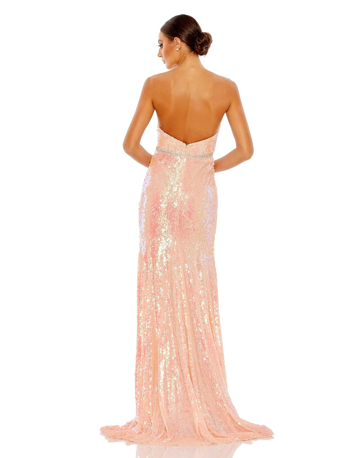 This elegant strapless, coral pink toned, floor length, fitted, formal dress is picture perfect. With an elongating column style and sequinned fabric with a gorgeous crystal belt to cinch in the waist, is finished with a glamorous sweeping train. This gown is perfect for wedding guests, special occasions and proms back view