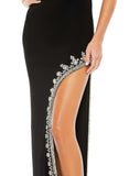 This elegant Mac Duggal, long, black, asymmetric evening gown with sexy crystal detail on the skirt is and an open back is a met gala inspired gown for a very special occasion! This elegant evening dress is the perfect dress perfect for proms, black-tie affairs, wedding guest and special events! prom gown