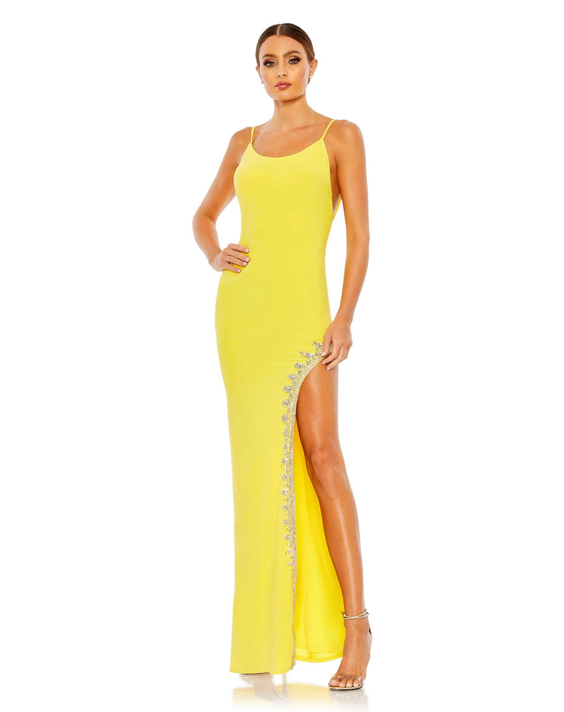 This elegant Mac Duggal, long, yellow, asymmetric evening gown with sexy crystal detail on the skirt is and an open back is a met gala inspired gown for a very special occasion! This elegant evening dress is the perfect dress perfect for proms, black-tie affairs, wedding guest and special events!