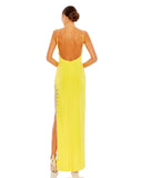 This elegant Mac Duggal, long, yellow, asymmetric evening gown with sexy crystal detail on the skirt is and an open back is a met gala inspired gown for a very special occasion! This elegant evening dress is the perfect dress perfect for proms, black-tie affairs, wedding guest and special events! back view