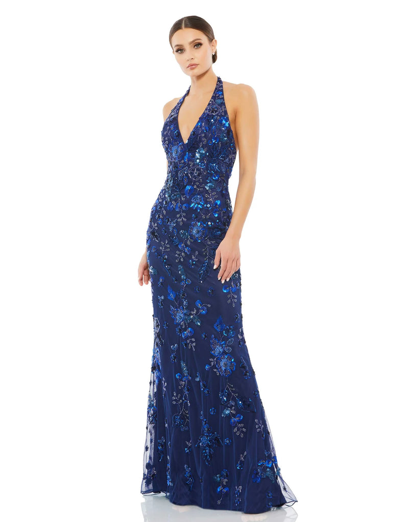 This elegant Mac Duggal short-sleeved, floor-length, halterneck, navy blue crystal and bead embellished evening dress is a stunning formal gown for your special occasions! With a  beautiful V neckline and a column style fit and low back detail, this dress will truly have you feeling picture perfect! 